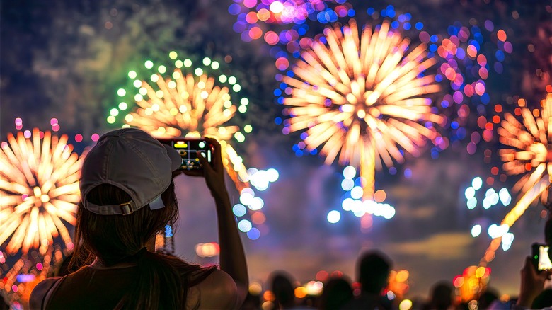 Person photographing a fireworks display