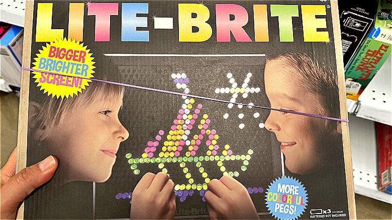 Hand holding vintage Lite-Brite box