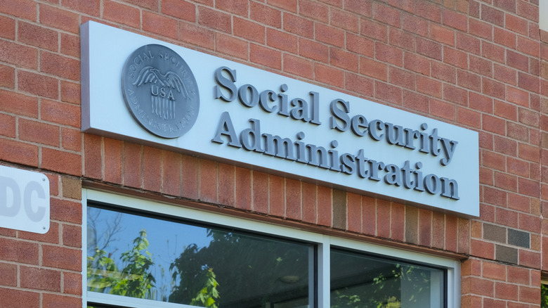 A brick-and-mortar Social Security Administration office door and sign.