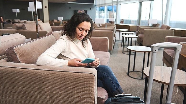 Person reading in airport lounge