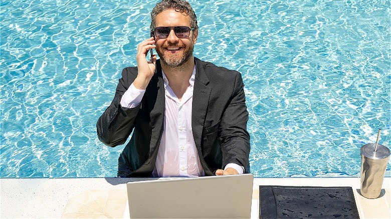 Person working from swimming pool