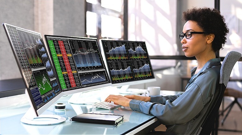 Person trading stocks with computers