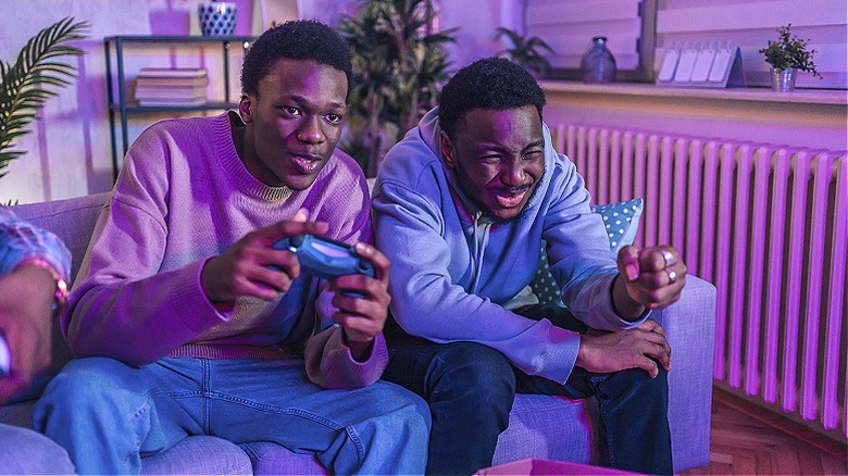 Two friends playing game console