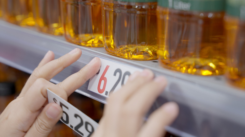 Worker replacing price tag on store item