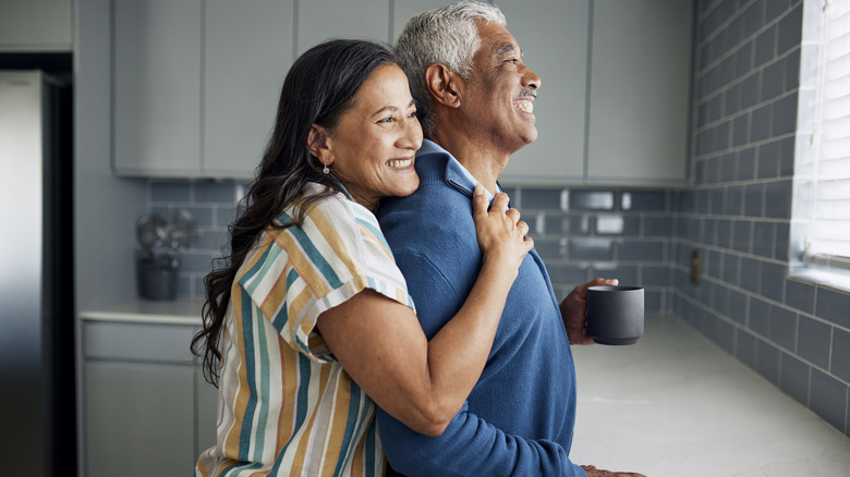 couple drinking coffee and looking out window