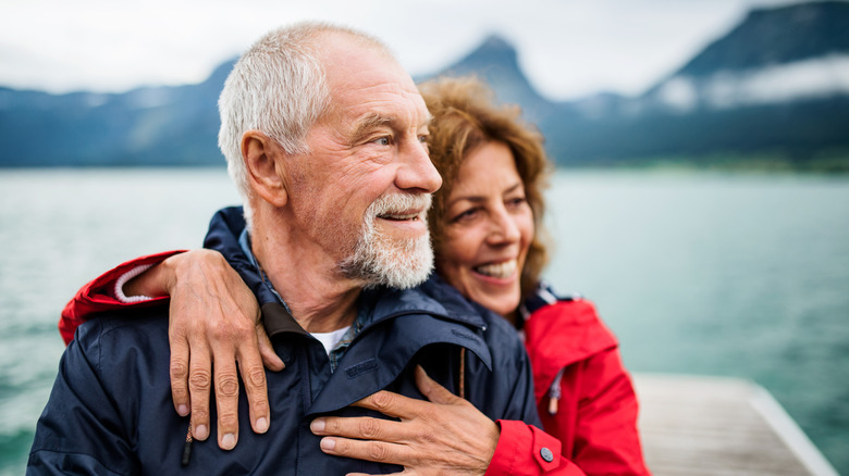 Old man and woman on a walk in summer, talking.