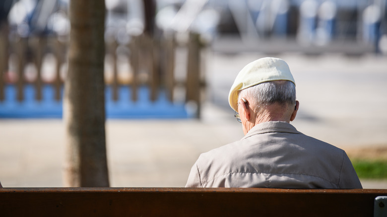 Elderly male sitting on a bench