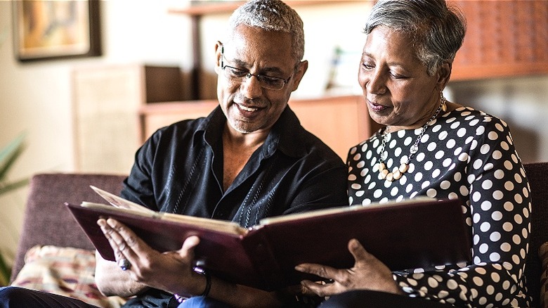 Senior couple viewing photo album