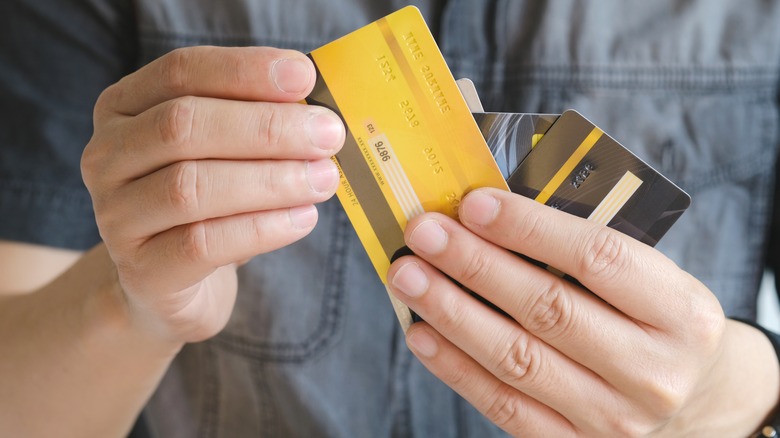 man holding credit cards