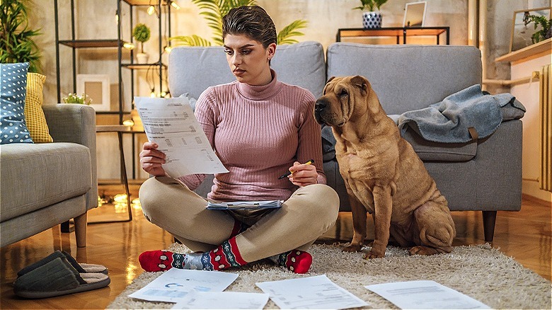 Person with dog reviewing paperwork