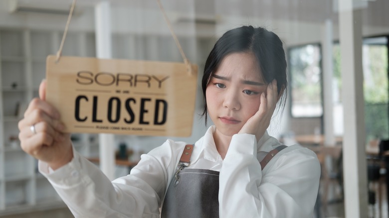 A woman hanging a sign