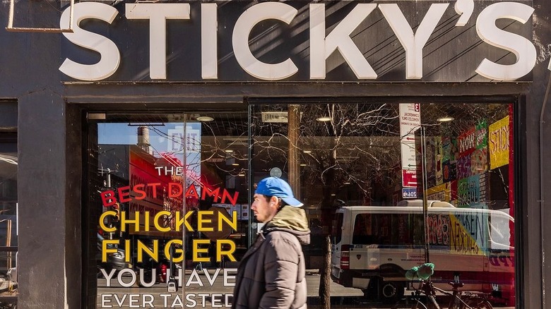 A man walking by a restaurant