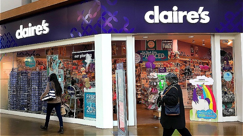 People walking past Claire's store