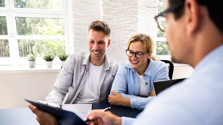 Financial advisor explaining project to young couple