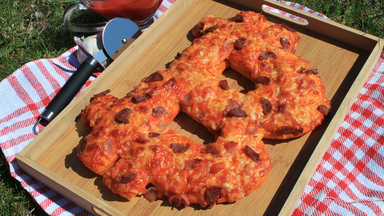 pizza shaped like bitcoin symbol