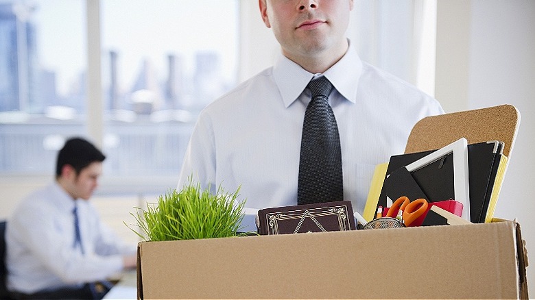 Person carrying box, leaving job