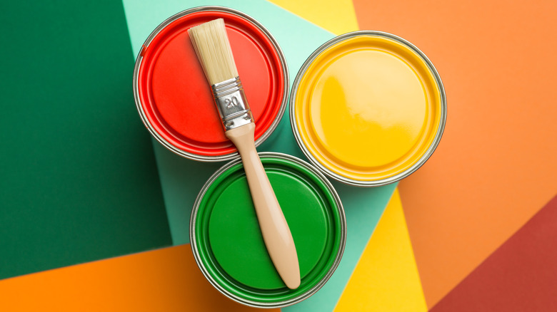 Three cans of colorful paint