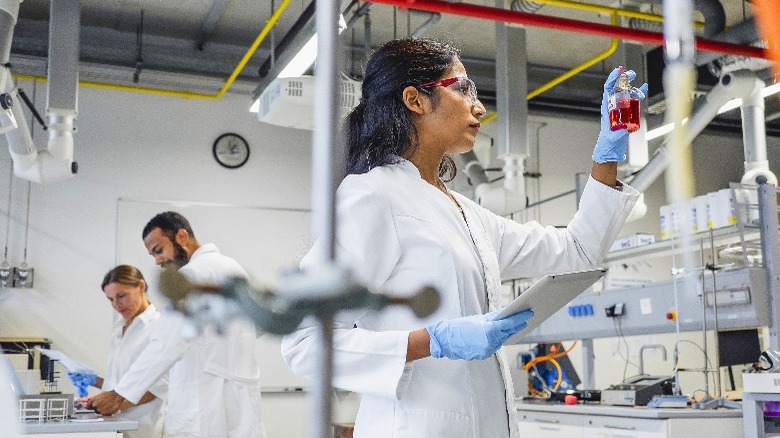 Three people working in laboratory