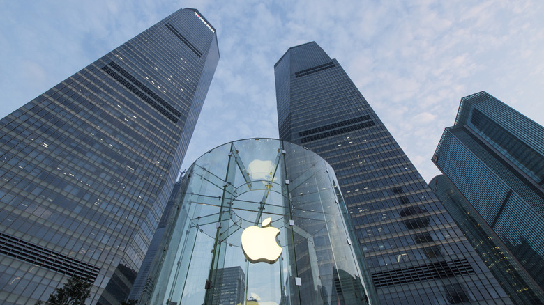 Office towers above a building with an Apple logo