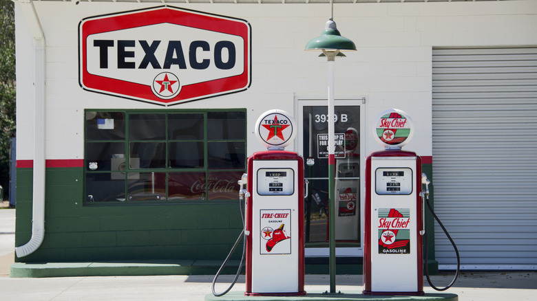 Two gas pumps at a vacant Texaco gas station