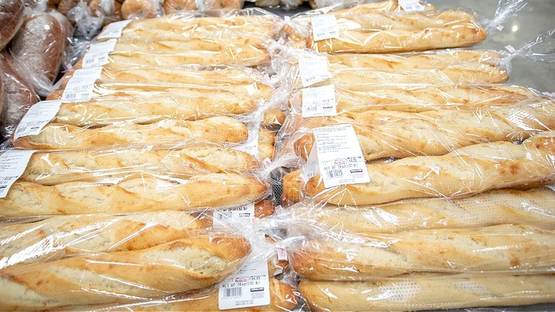 A table full of Costco's bagged baguettes