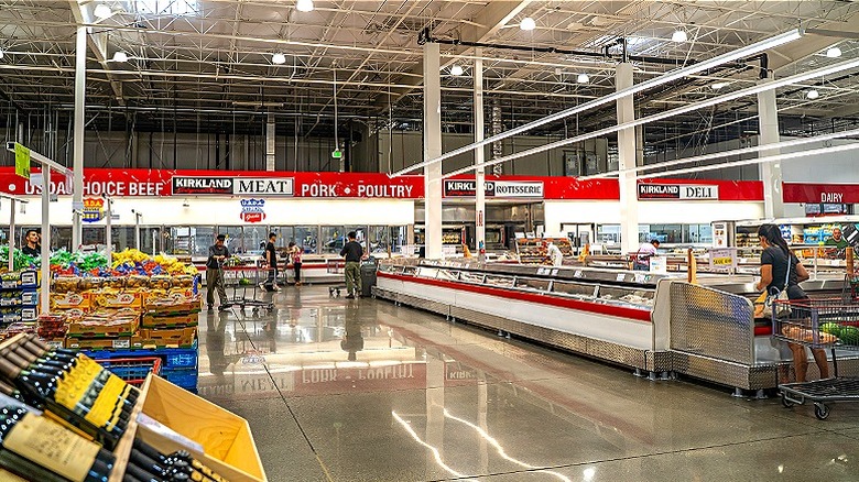 A wide shot of Costco's wine and grocery section with shoppers