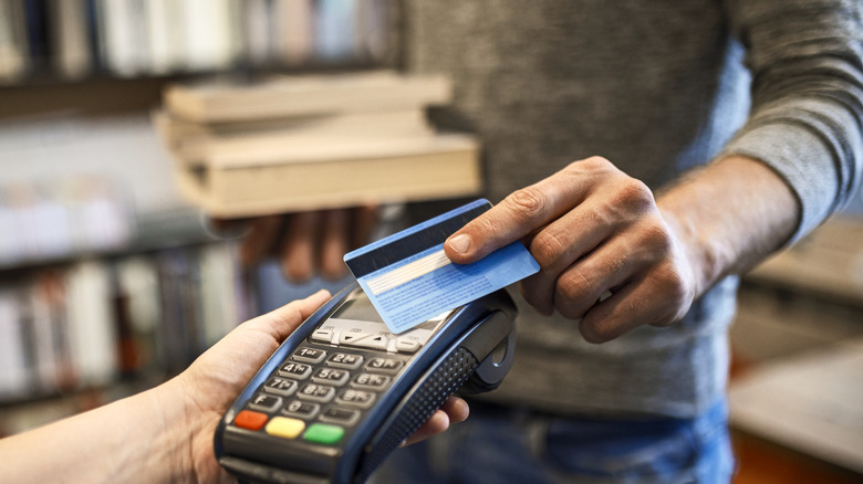 Person using debit card for purchase