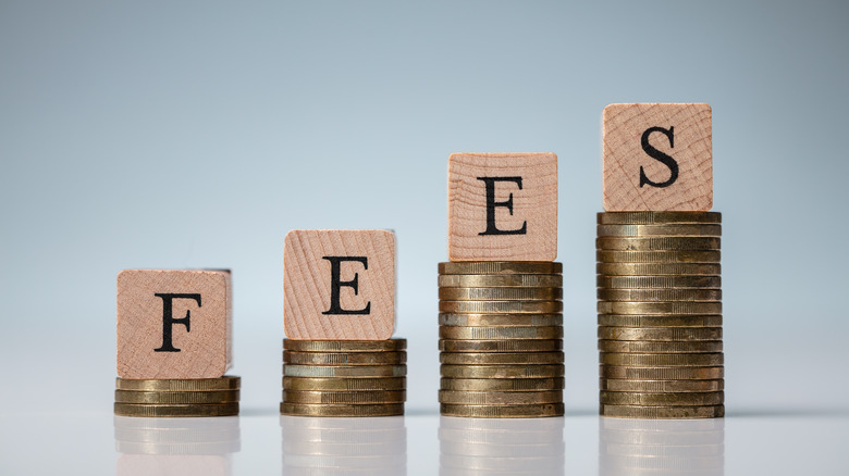 Fees spelled out in blocks stacked on coins