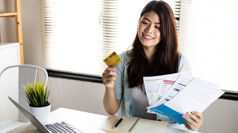 woman holding credit card statement