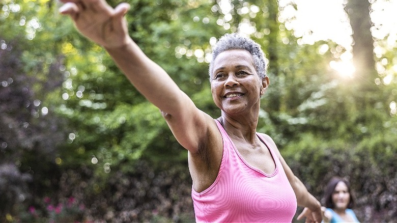 Older person doing yoga outside