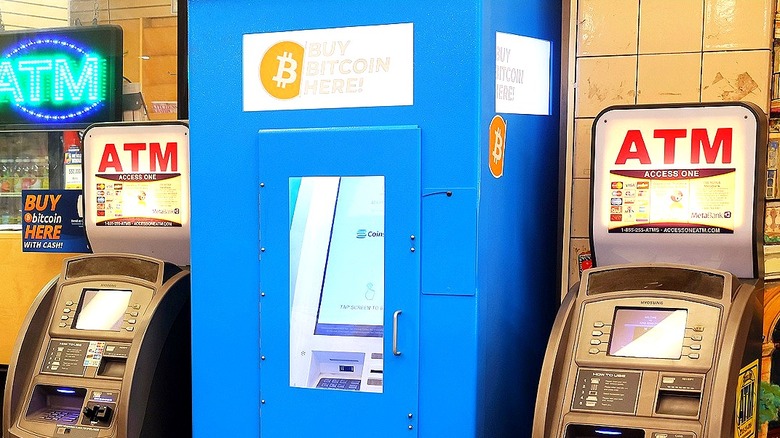 Bitcoin ATM surrounded by regular ATMs outside convenience store