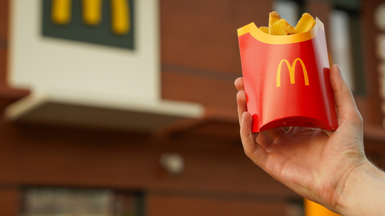 a hand holding a McDonald's pack