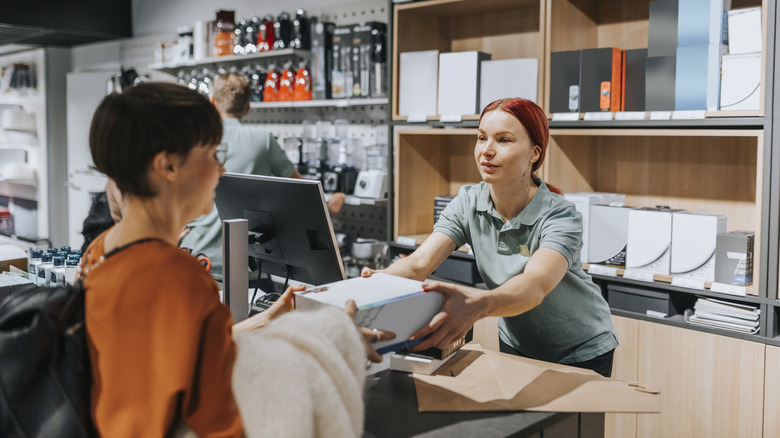 A woman at a store selling an old electronics