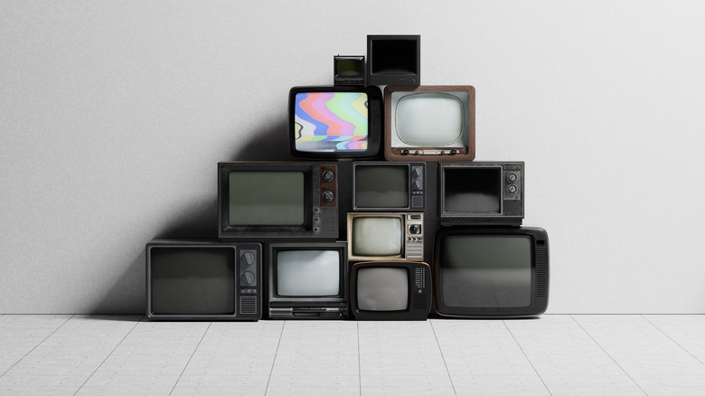 Conceptual image of a stack of old analog TV sets with blank screens