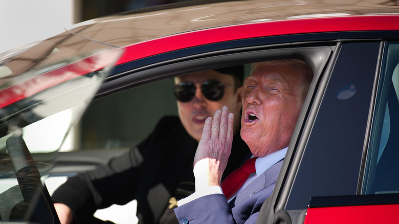 Elon Musk and Trump in a red sports car