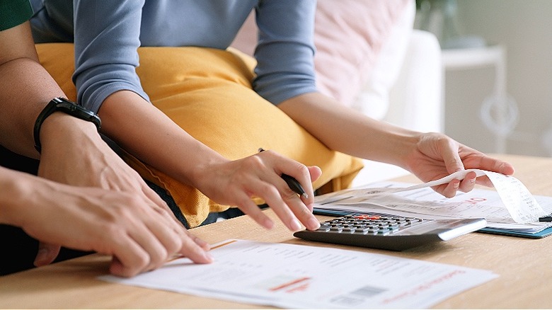 Couple making calculations at home