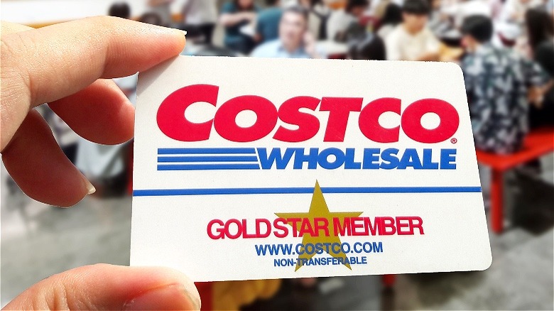 Hand holding Costco membership card