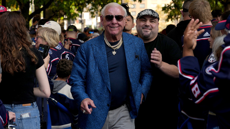 Ric Flair surrounded by fans
