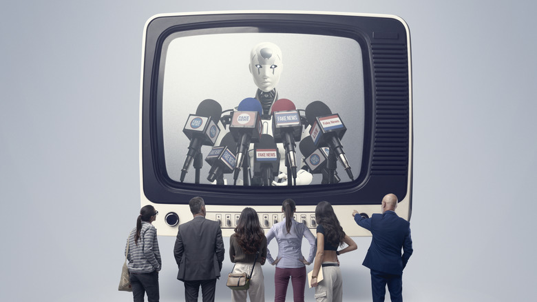 A group of people watch an oversized, retro-styled TV with a crash test dummy giving a press conference to multiple news outlets, represented by many different microphones.