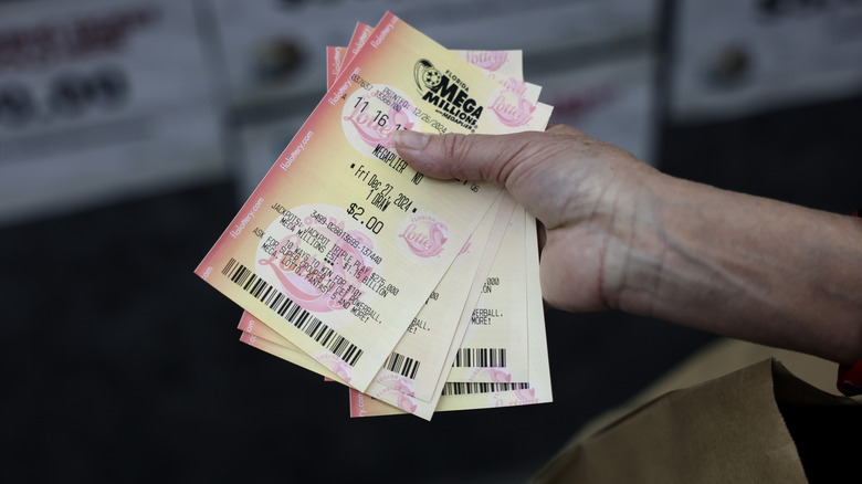 A customer plays Mega Millions lottery at the Downtown Miami Souvenirs store