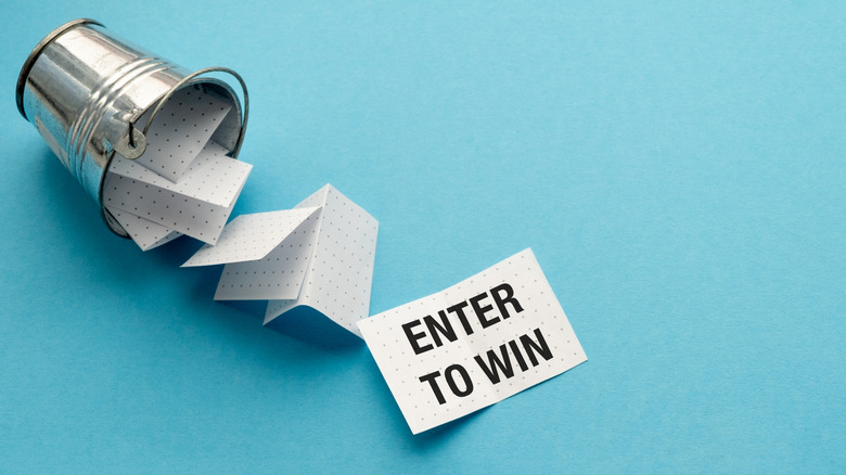 A bucket spills over some pieces of paper with the writing "Enter to win"