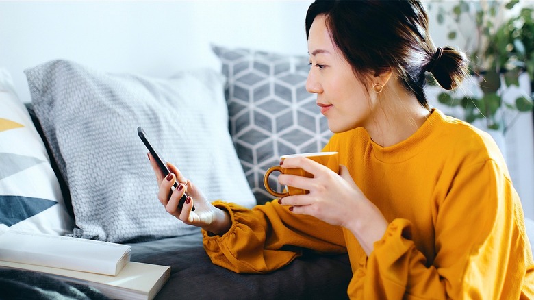 Person using smartphone at home