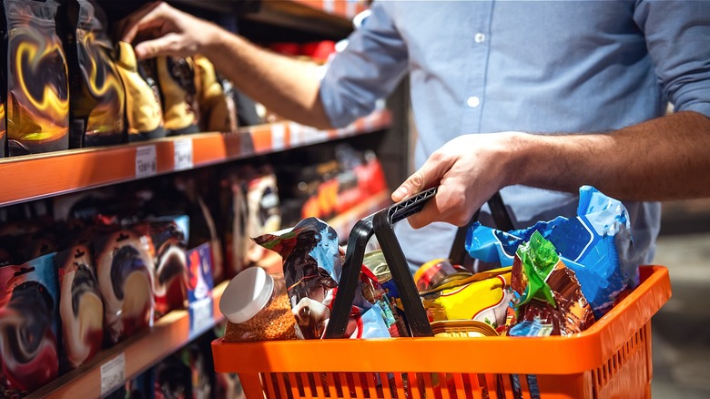 Person grocery shopping with basket