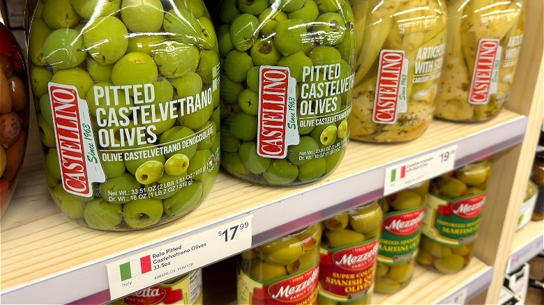 Jars of olives at grocery store