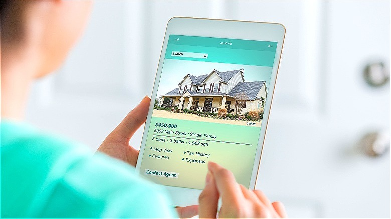 Person reviewing online home listings