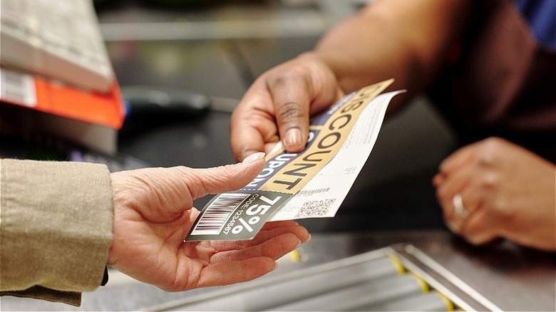 People exchanging grocery store coupons