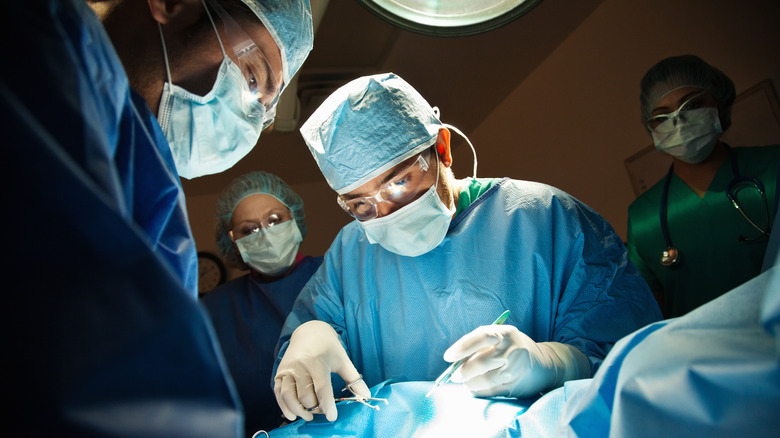 A surgeon performing a c-section