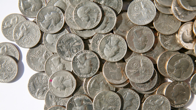 A pile of 1776-1976 Quarters isolated on white.