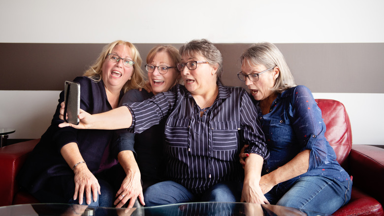 a group of older women posing for a selfie