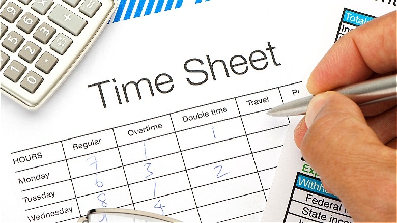 Person filling out time sheet